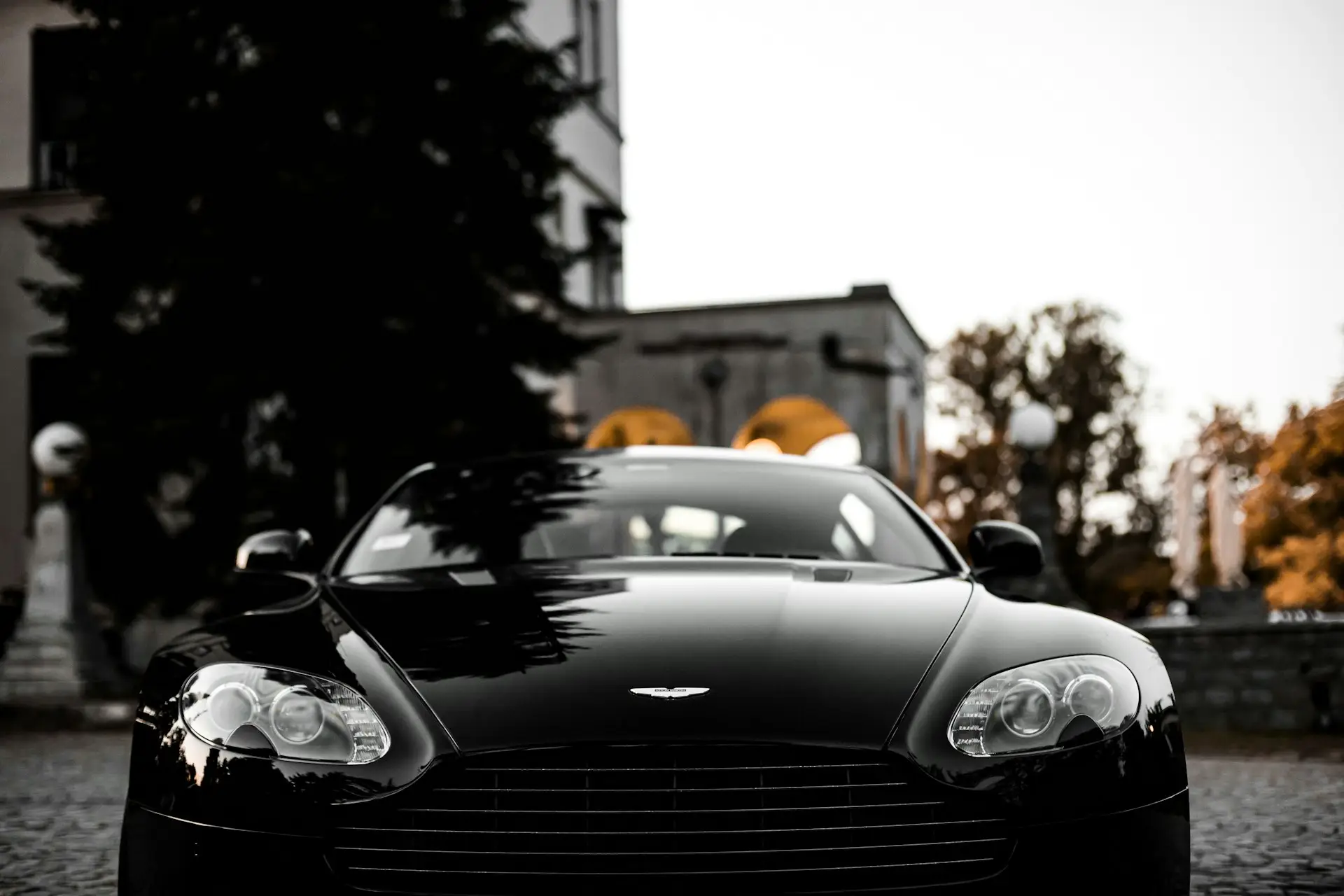 Sleek Black Sports Car Front View Close-up of the front of a black sports car, showcasing its headlights and grille.