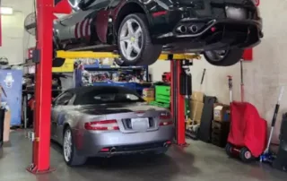 Cars on Lifts in Auto Repair Shop Two cars on lifts in a garage with tools and equipment