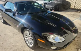 Black Jaguar Convertible Sports Car Black convertible Jaguar sports car parked on concrete